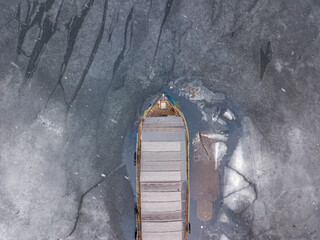 A ship in a frozen bay. Aerial drone top view.
