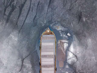 A ship in a frozen bay. Aerial drone top view.