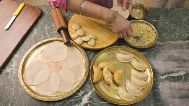 An Indian woman preparing gujia, an Indian popular snack especially made in Holi festival of colors
