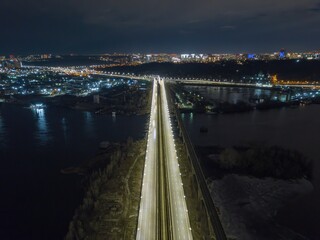 Automobile and railway bridge in Kiev. Night illumination of the bridge. Aerial drone view.