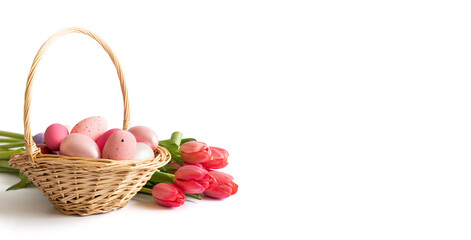 Fototapeta na wymiar Easter pink eggs in a basket and a bouquet of pink red tulips isolated on a white background. Easter composition. Banner. Copy space.