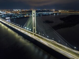 Fototapeta na wymiar South automobile bridge in Kiev. Night illumination of the bridge. Aerial drone view.