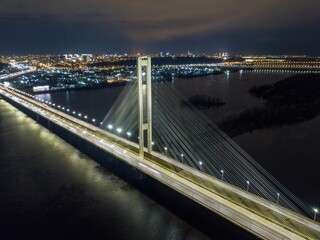 Fototapeta premium South automobile bridge in Kiev. Night illumination of the bridge. Aerial drone view.