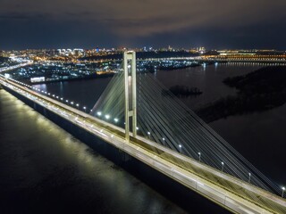 Obraz premium South automobile bridge in Kiev. Night illumination of the bridge. Aerial drone view.
