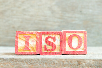 Color alphabet letter block in word iso on wood background