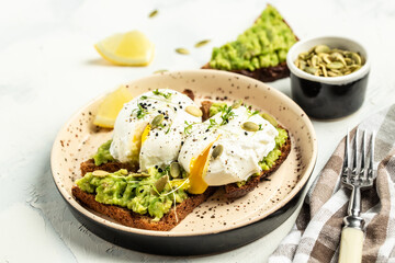 sandwich with avocado and poached eggs, Healthy food concept