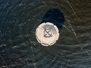 Deviation tower on the water. Aerial drone view.