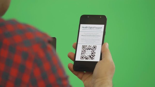 Hand holding smartphone with digital health passport COVID certificate