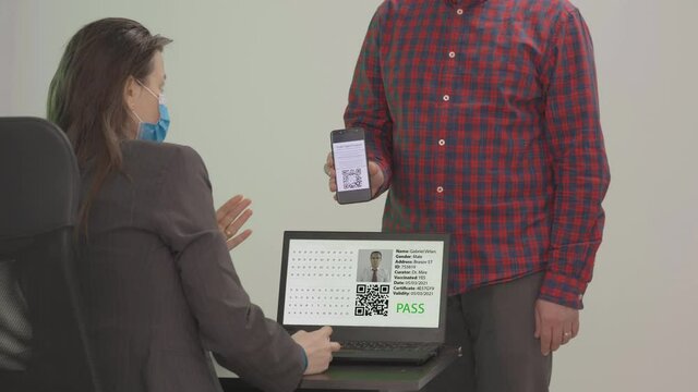 Man being accepted on access after scanning valid digital health vaccination passport certificate, controlled pass during COVID-10 Coronavirus pandemic restrictions