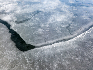 Crack of ice on the river. Aerial drone view.