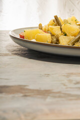 Exquisite natural and fresh homemade salad of potatoes, green beans, egg and cherry tomato with olive oil and aceto. Healthy and organic food.