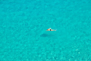 the young woman swims alone