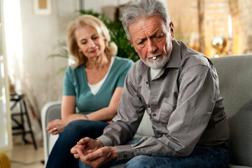 Senior man having a problem. Wife comforting her sad husband.