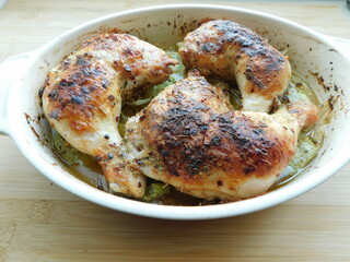Chicken Legs with Vegetables on wooden table.