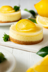 Cheesecake lemon tart cake or pie, with fresh lemon and mint. White background, lifestyle healthy desert.