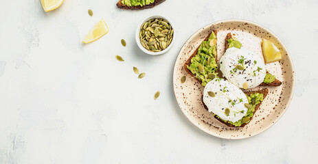 sandwich with avocado and poached egg. Healthy food concept. banner, menu recipe place for text, top view