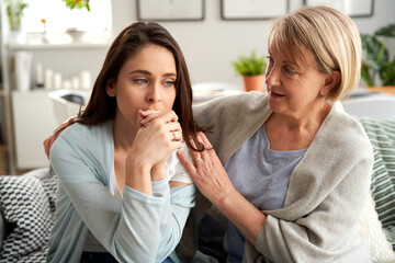 Mother comforting upset adult daughter