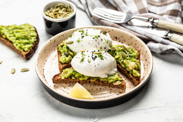 sandwich with avocado and poached egg. Healthy food concept. Food recipe background. Close up
