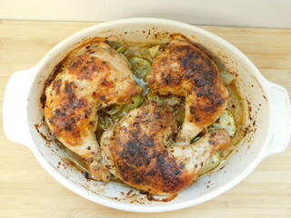 Chicken Legs with Vegetables on wooden table.