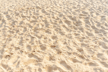 Fototapeta na wymiar Sand on the beach as background. Light beige sea sand texture pattern, sandy beach background.