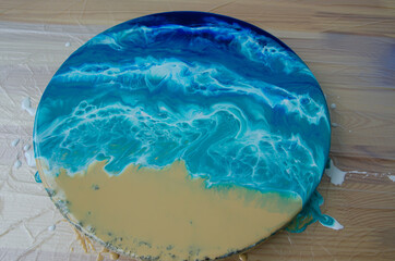 Epoxy resin art. Imitation of the sea. Sea foam. Modern trendy hobby. Macro photo. Pouring process