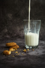 a glass of milk with cookies