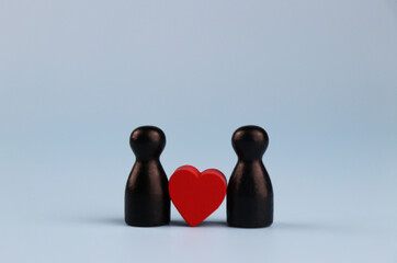 Couple and red heart on blue background