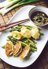 Gyoza dumplings with grilled asparagus