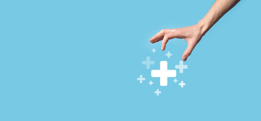 Male hand holding plus icon on blue background. Plus sign virtual means to offer positive thing like benefits, personal development, social network Profit,health insurance, growth concepts
