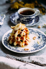 Belgian waffles with banana and honey on a vintage blue plate