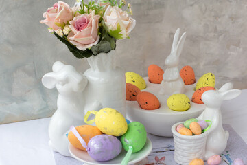 Easter bunnies and eggs on the table. Beautiful Easter greeting card. The minimal concept of Easter. Copy space