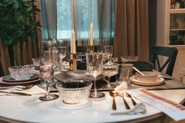 Restaurant. An elegantly laid dining table with dishes and cutlery for several people. Close up. Nobody