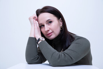 Fashion portrait of a young brunette woman in a dark golf