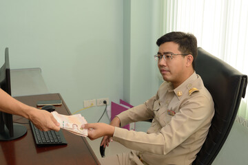 A Thai government officer, Civil servant receive money from bribes.
