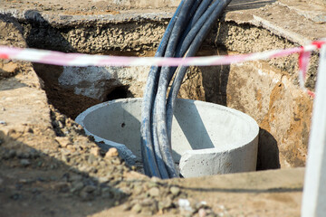 Construction pit with communication, water supply hoses,