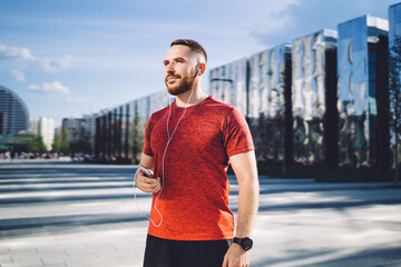 Sportsman listening to music in earphones