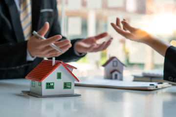 Model homes and real estate agents for sale of a home during insurance or on a real estate loan or property background, Mortgage loan approval home loan and insurance concept.
