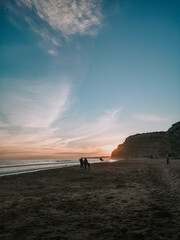 Fototapeta na wymiar silhouette of a person walking on the beach