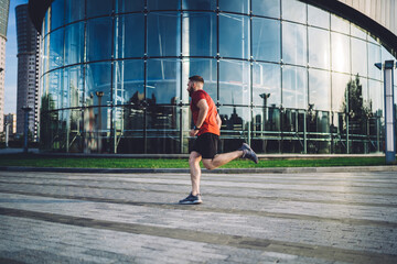 Sporty male runner practicing in downtown