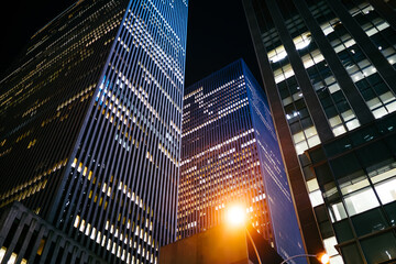 Fototapeta na wymiar Modern skyscrapers on dark night street