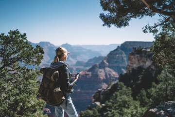 Anonymous female hiker admiring mountain landscape