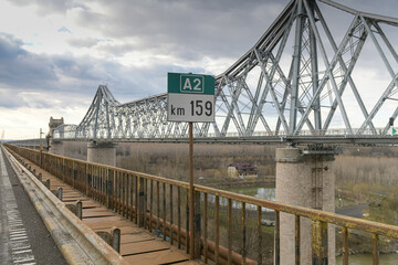 Fototapeta premium Cernavoda Bridge on A2 highway in Romania. The road to Black Sea. Historic infrastructure over Danube River.