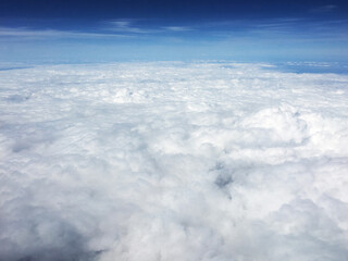 view of clouds over the clouds from the plane