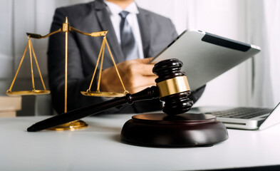 Business and lawyers discussing contract papers with brass scale on desk in office. Law, legal services, advice, justice and law concept picture with film grain effect