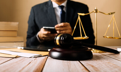Business and lawyers discussing contract papers with brass scale on desk in office. Law, legal services, advice, justice and law concept picture with film grain effect