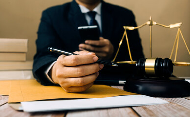 Justice and law concept.Male judge in a courtroom with the gavel, working with, computer and...
