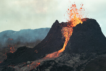 Volcanic eruption in Iceland, lava bursting from the volcano. Red and yellow magma. 