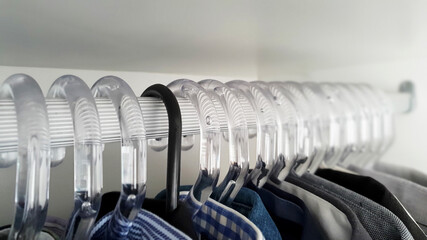 Diversity, Inclusion and Equality concept. Clothes hangers in a closet.