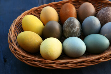 Naturally dyed Easter eggs in the basket. 