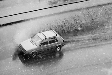 Snow storm in spring and cars